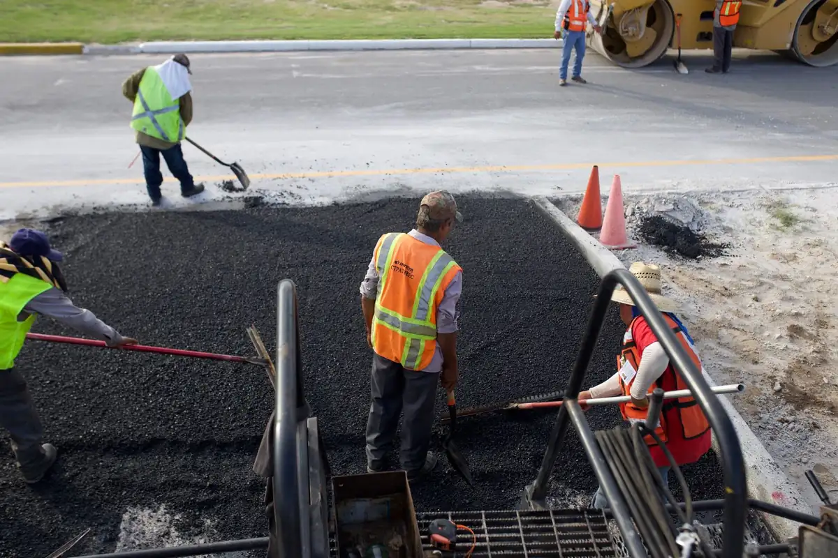 Iron Ridge Pavement crew laying fresh asphalt on a road in Central Florida